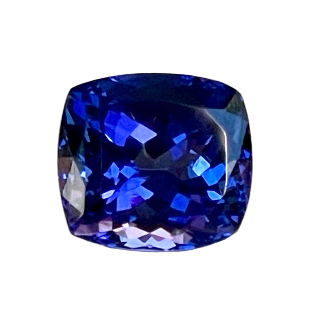 Gorgeous, tanzanite, old mine material, blue-blue with hint of violet, occasional red flashes. Cushion cut with precision faceting.