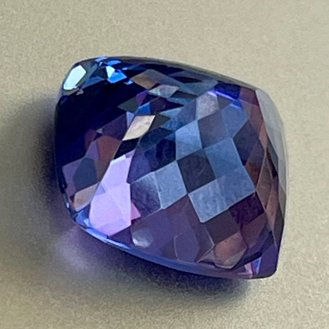 Gorgeous, tanzanite, old mine material, blue-blue with hint of violet, occasional red flashes. Cushion cut with precision faceting.