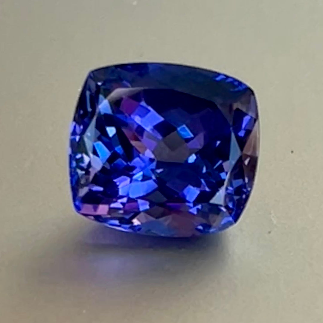 Gorgeous, tanzanite, old mine material, blue-blue with hint of violet, occasional red flashes. Cushion cut with precision faceting.